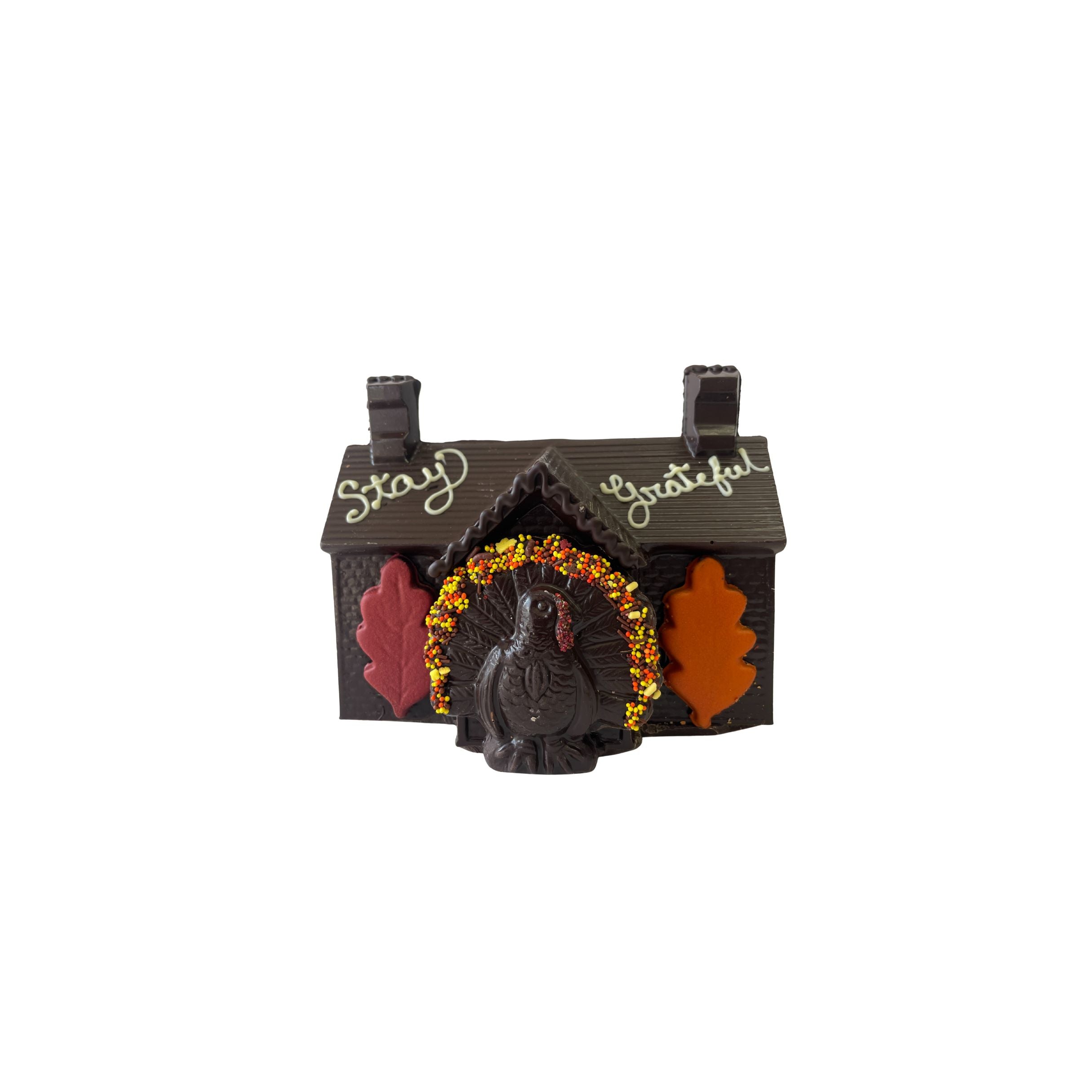 Decorative chocolate house with a turkey design and 'Stay Grateful' text on a white background