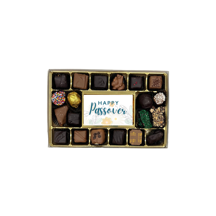 Box of assorted chocolates with a 'Happy Passover' card on a white background