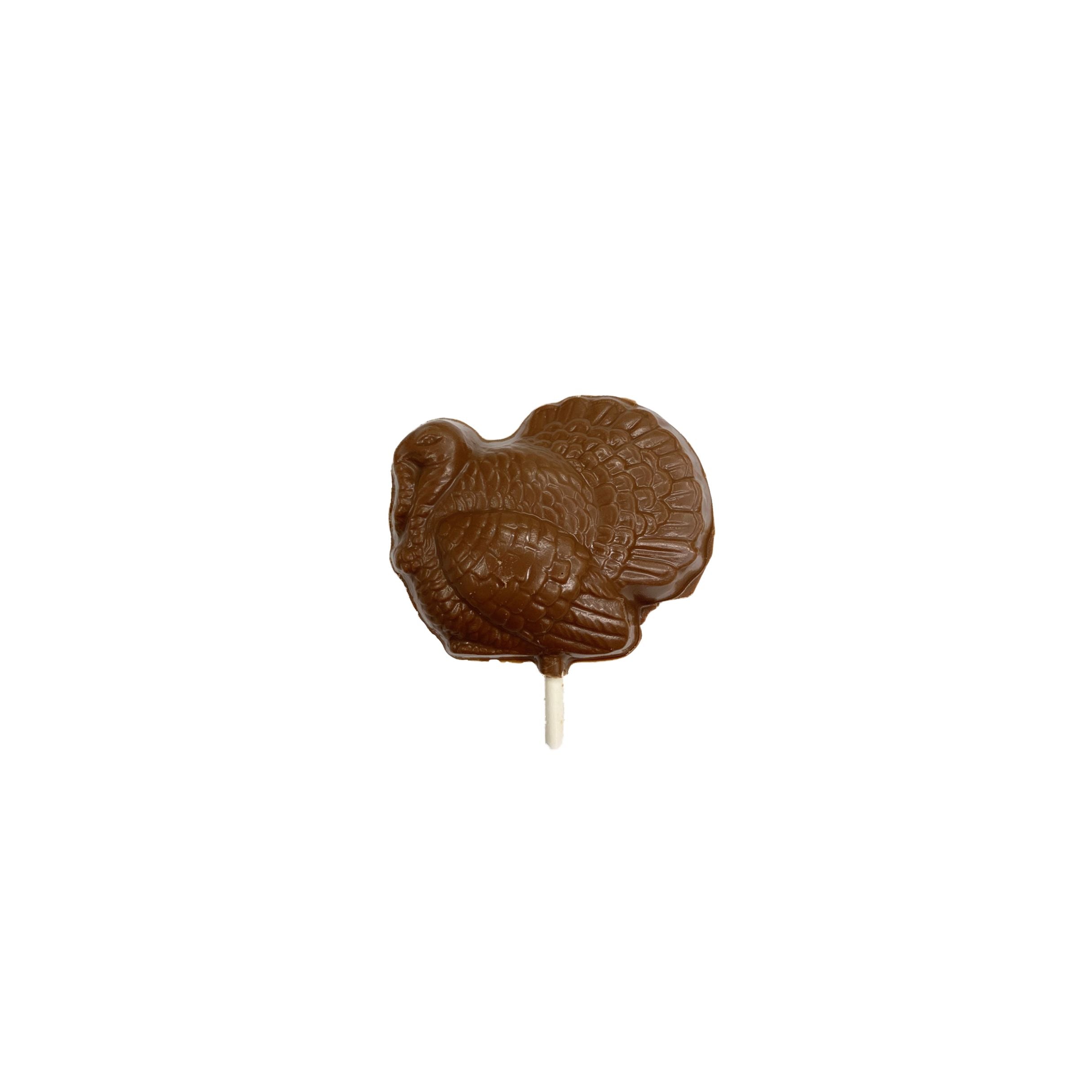 Chocolate lollipop shaped like a turkey on a white background