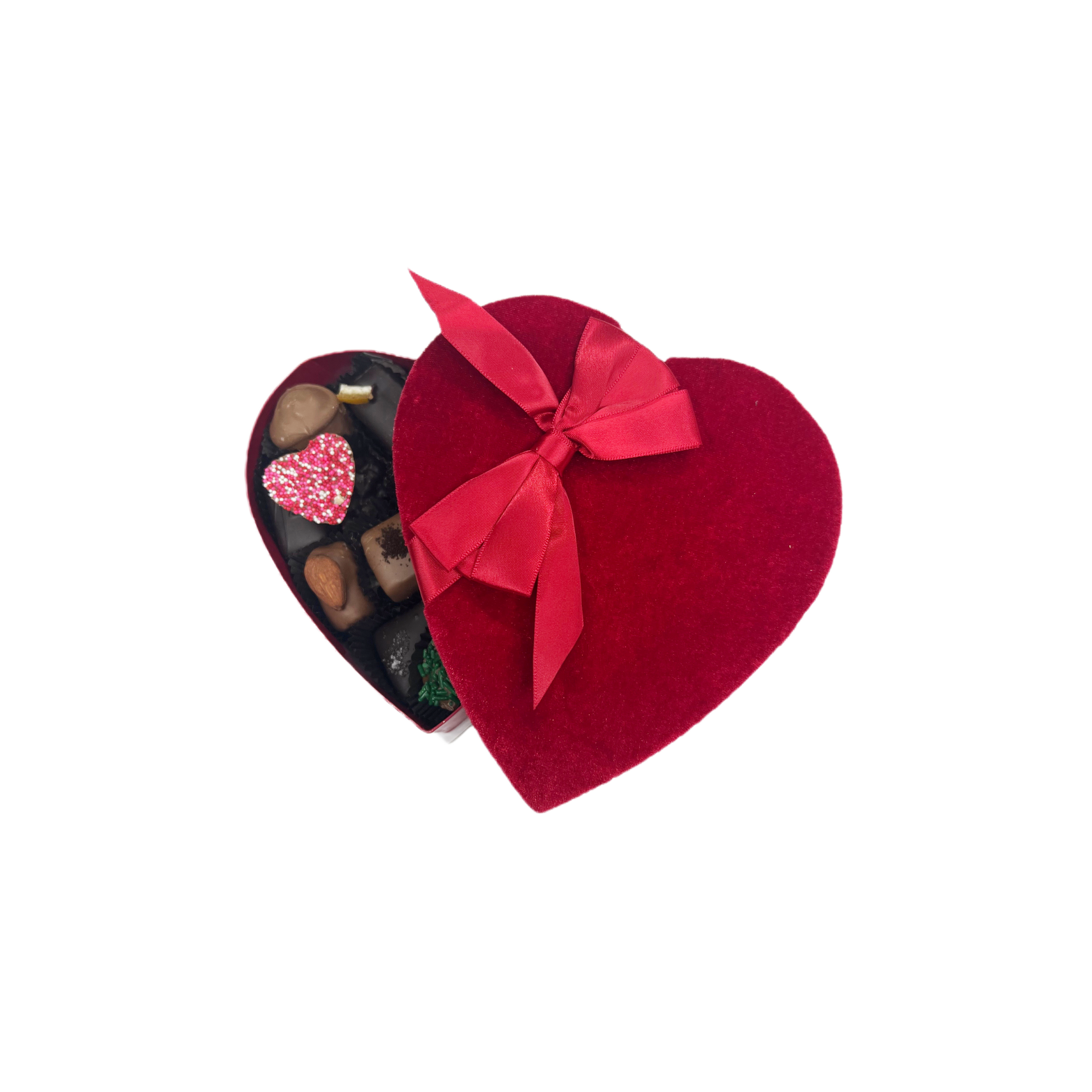 Heart-shaped chocolate box with a red ribbon on a white background