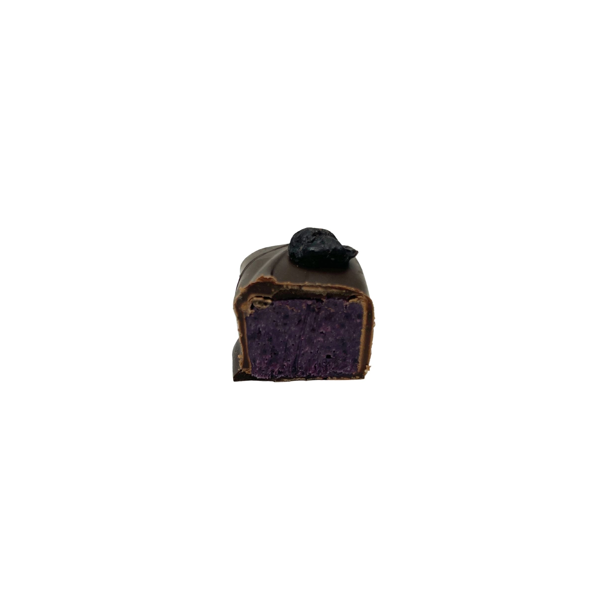 A single square chocolate confection with a dark purple interior and a small black topping, centered on a plain white background.