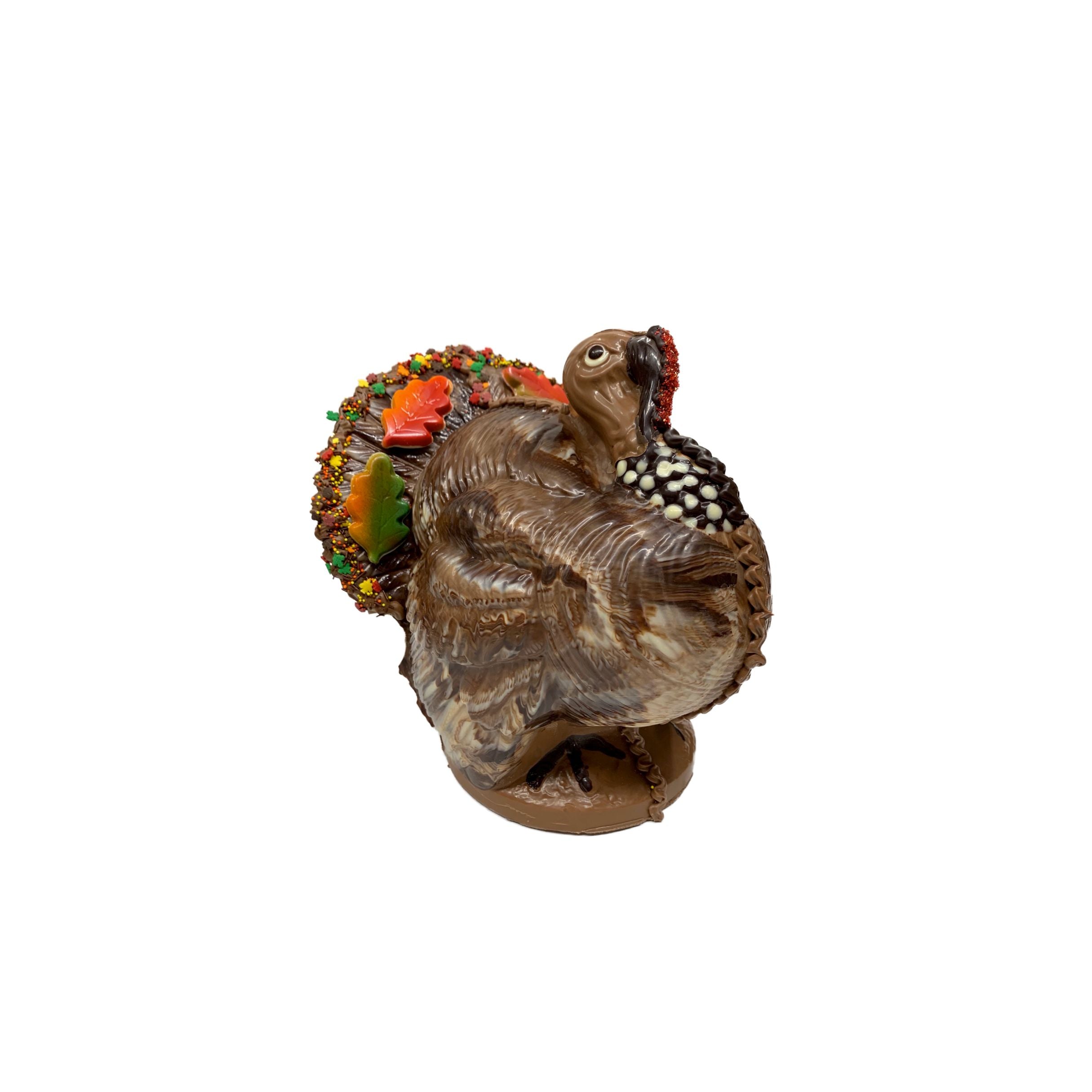 Decorative chocolate turkey with a colorful tail on a white background