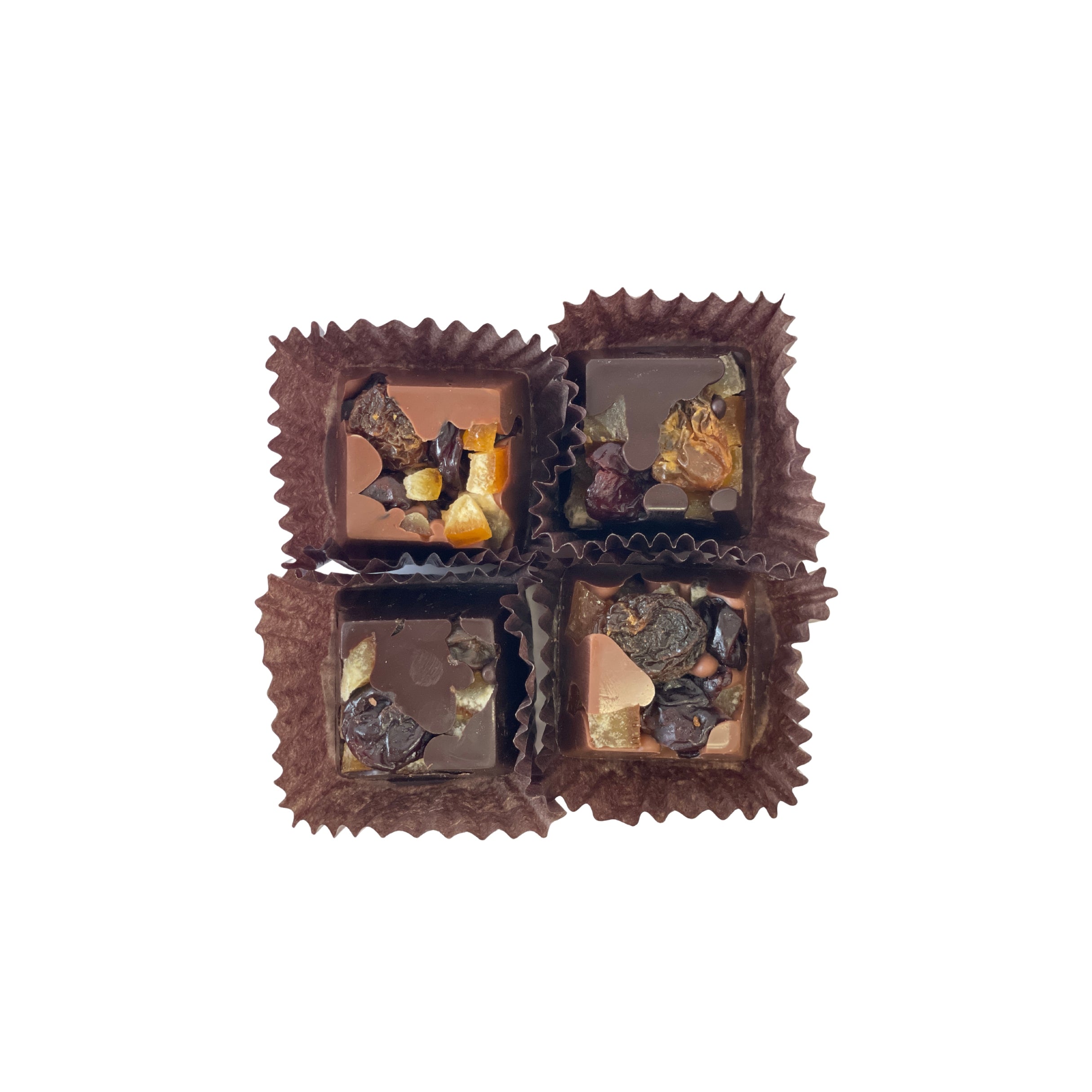 Four chocolates in brown cups on a white background