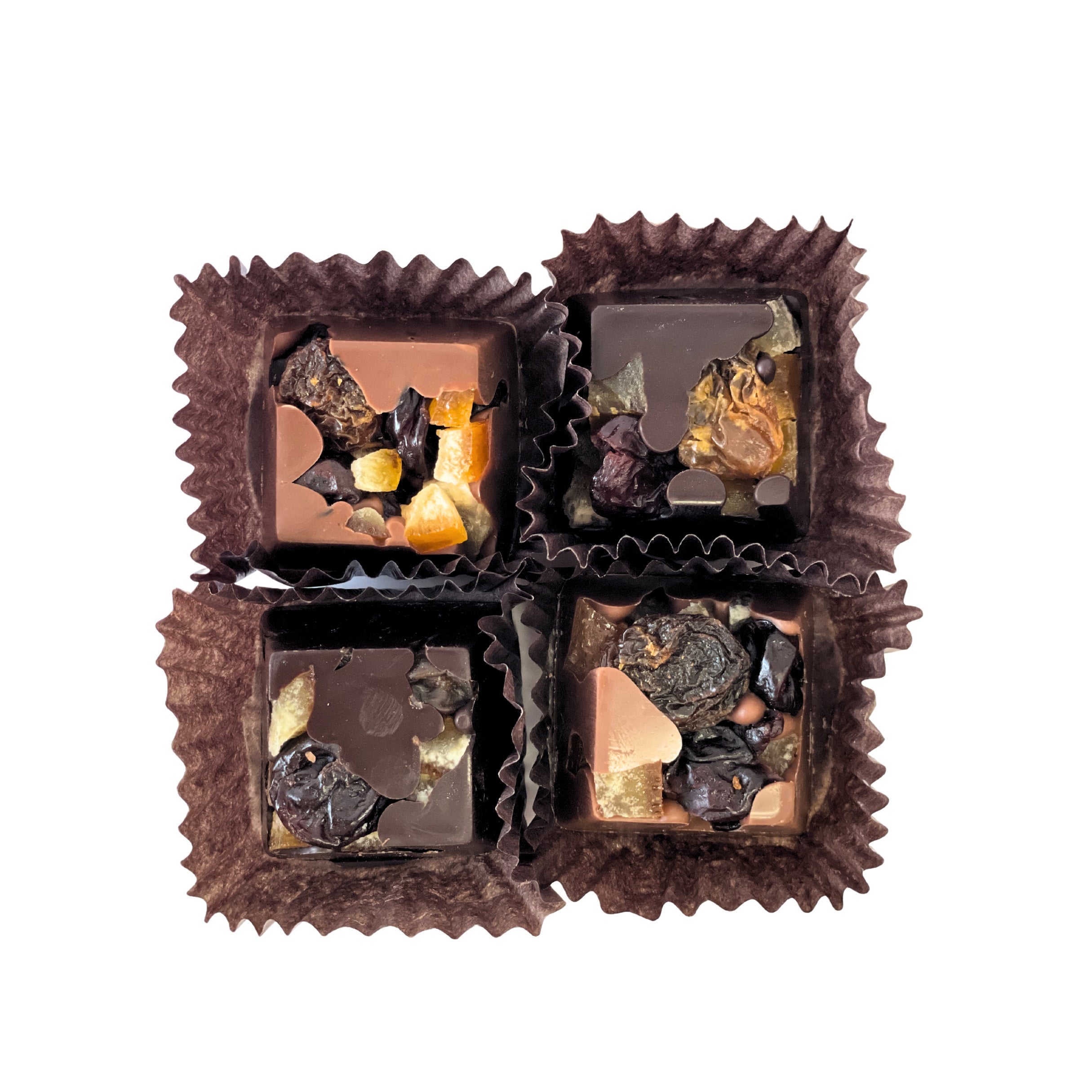 Four chocolates in brown cups on a white background