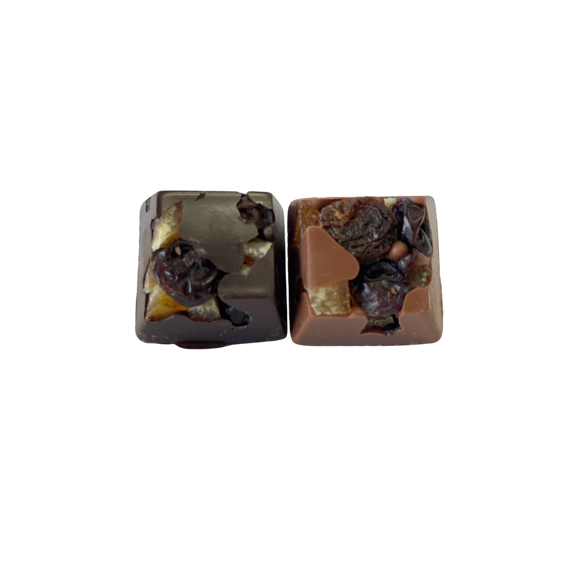 Two square-shaped chocolate candies with visible nuts and fruits on a white background