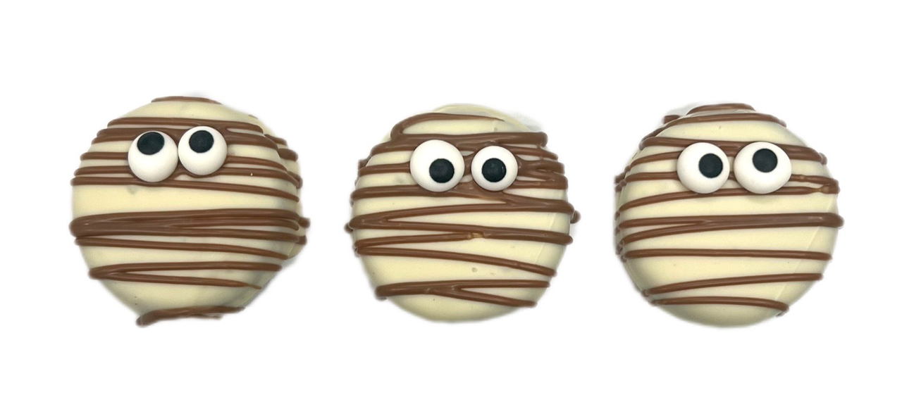 milk chcolate oreos with white chocolate lines and sugar eyes