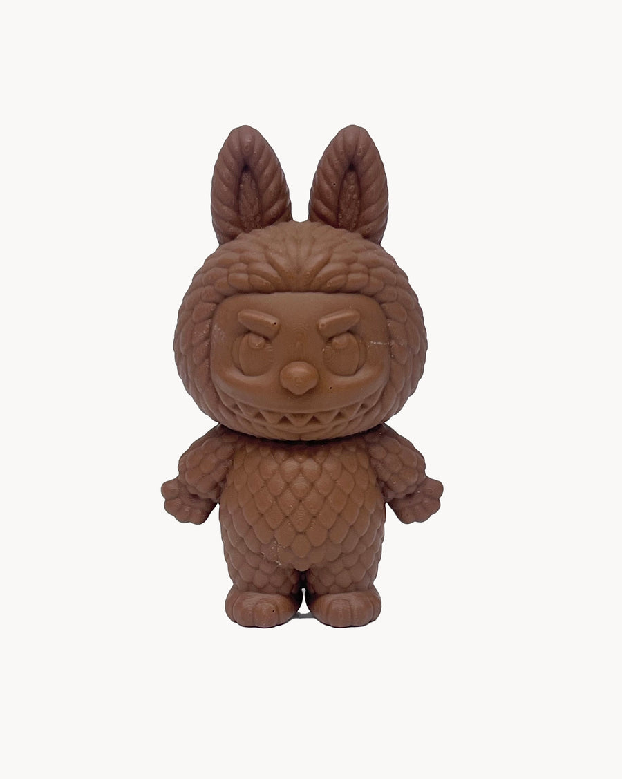 chocolate item with a quilted design and ears on a white background