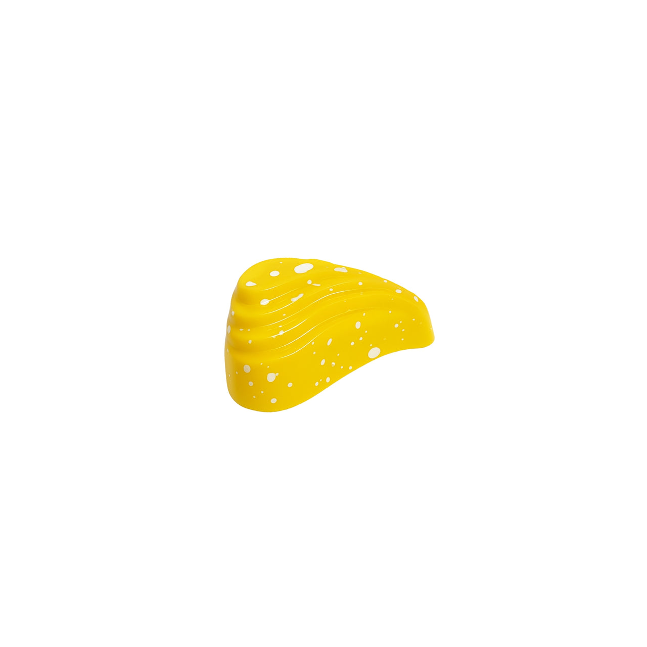 Yellow object with white speckles on a white background