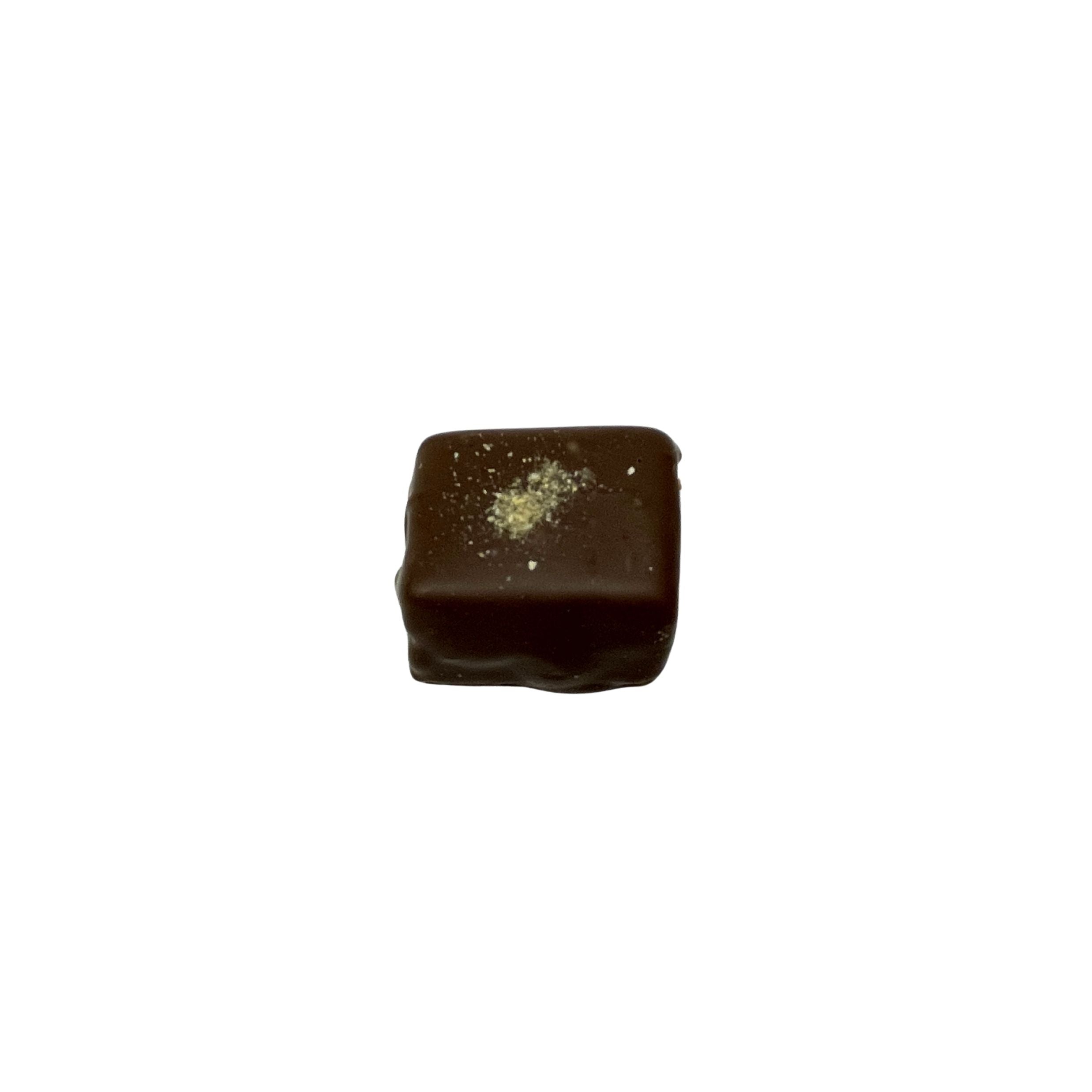 A single square piece of dark chocolate with a small dusting of powdered sugar on top, isolated on a solid white background.