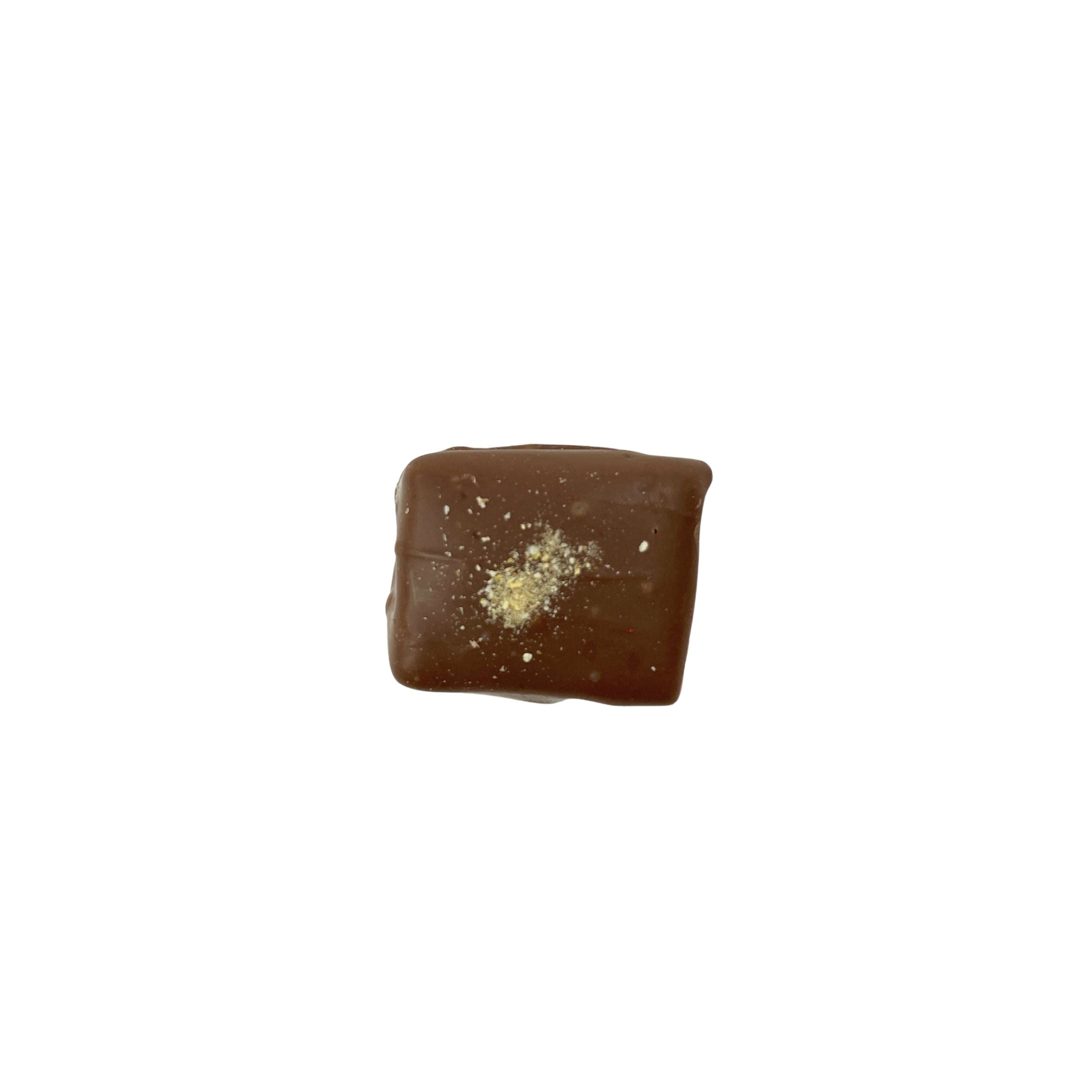 A single square piece of dark chocolate with a small dusting of powdered sugar on top, isolated on a solid white background.