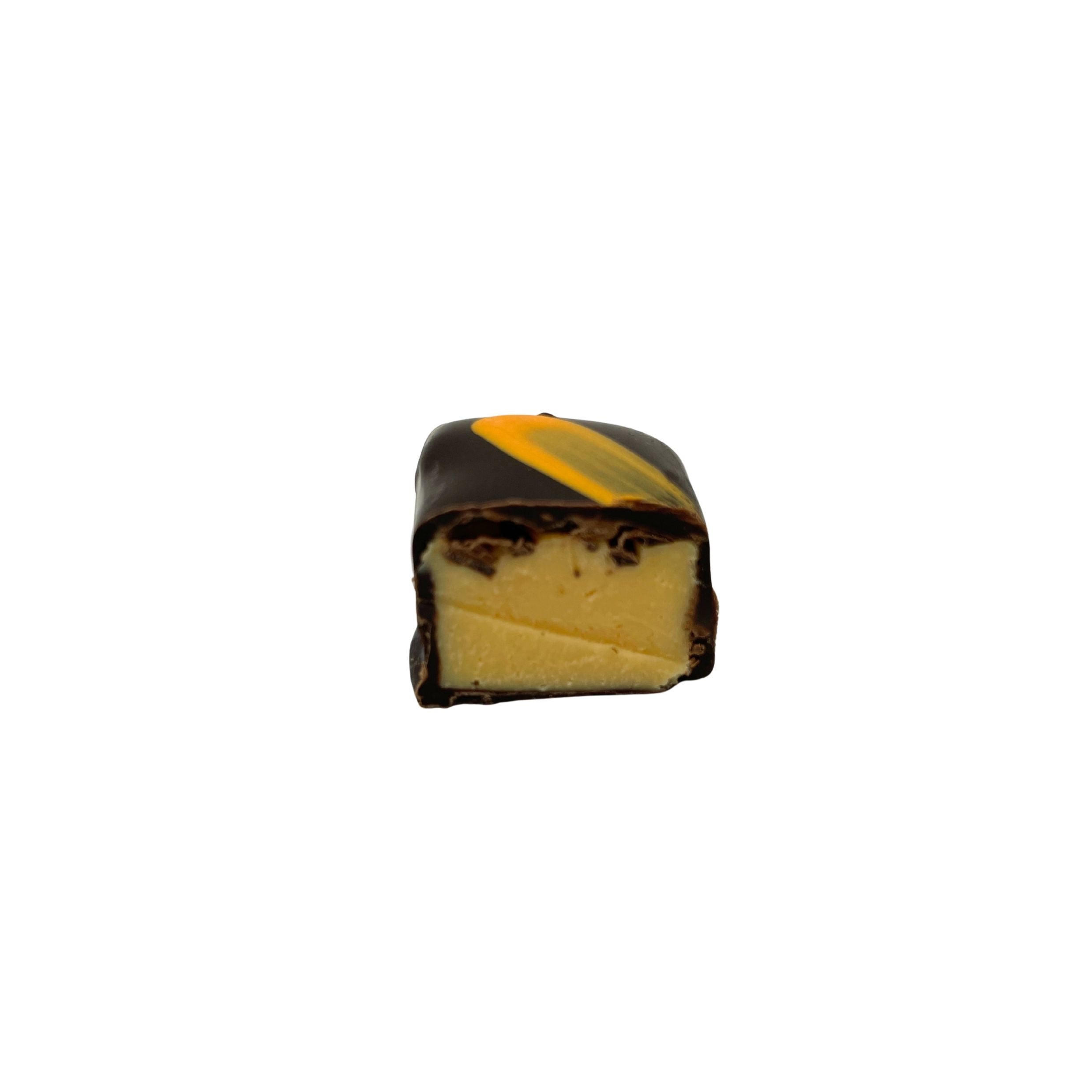 A single square chocolate confection with a dark chocolate coating, a pale cream-colored center, and a diagonal yellow accent on top, isolated on a white background.
