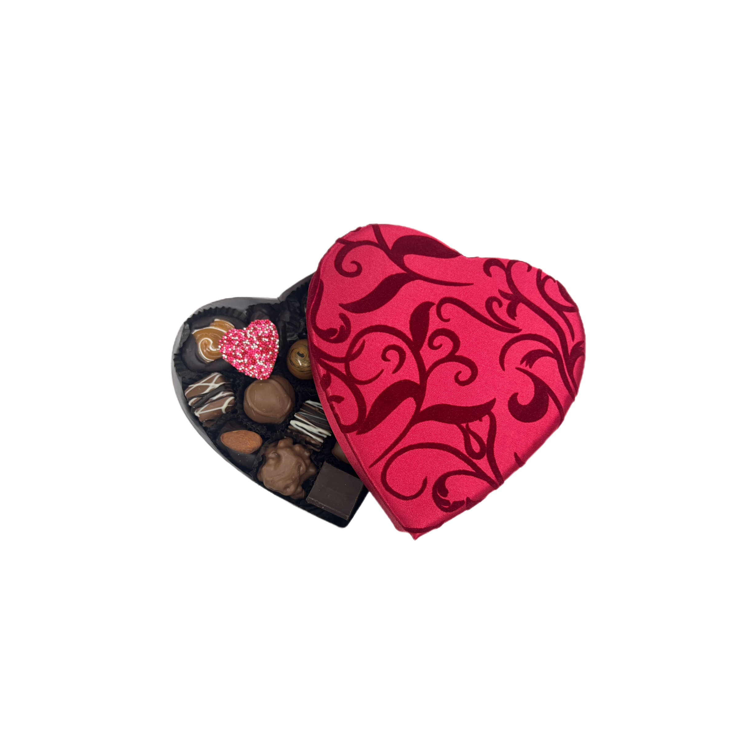Heart-shaped chocolate box with a pink and black pattern containing assorted chocolates on a white background.