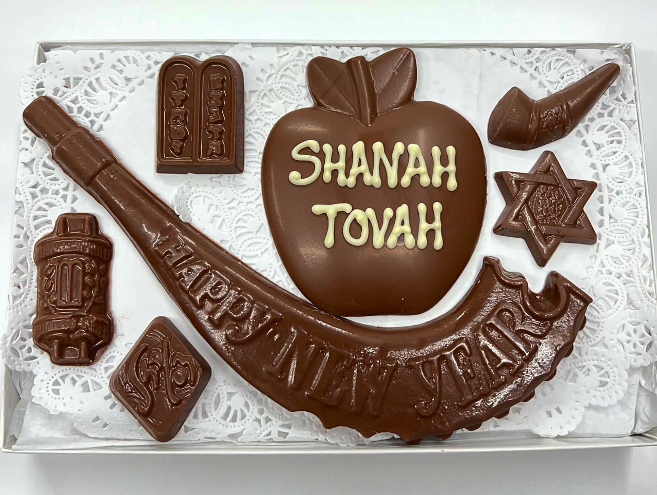 open box with white tissue with dark chocolates