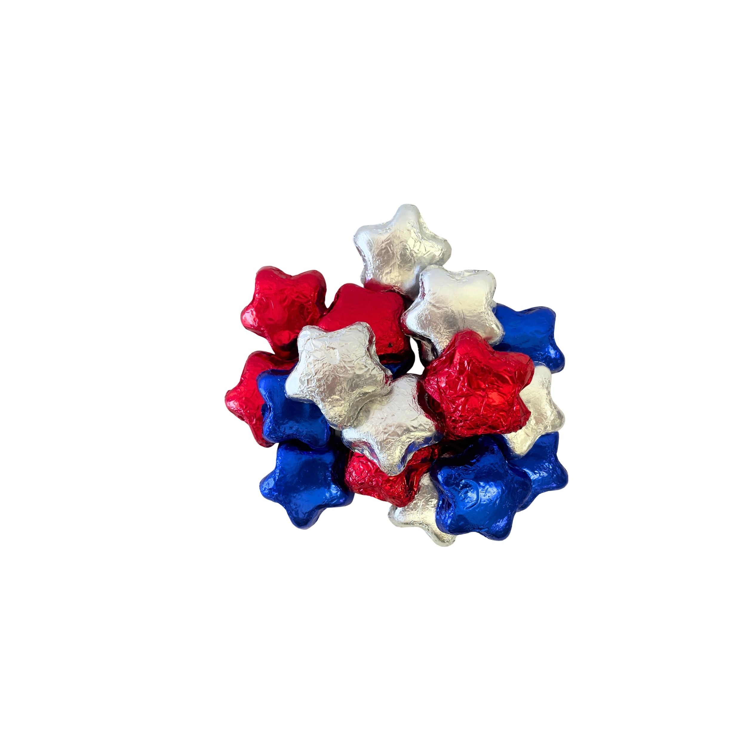 A small pile of foil-wrapped star-shaped candies in red, white, and blue on a plain white background.
