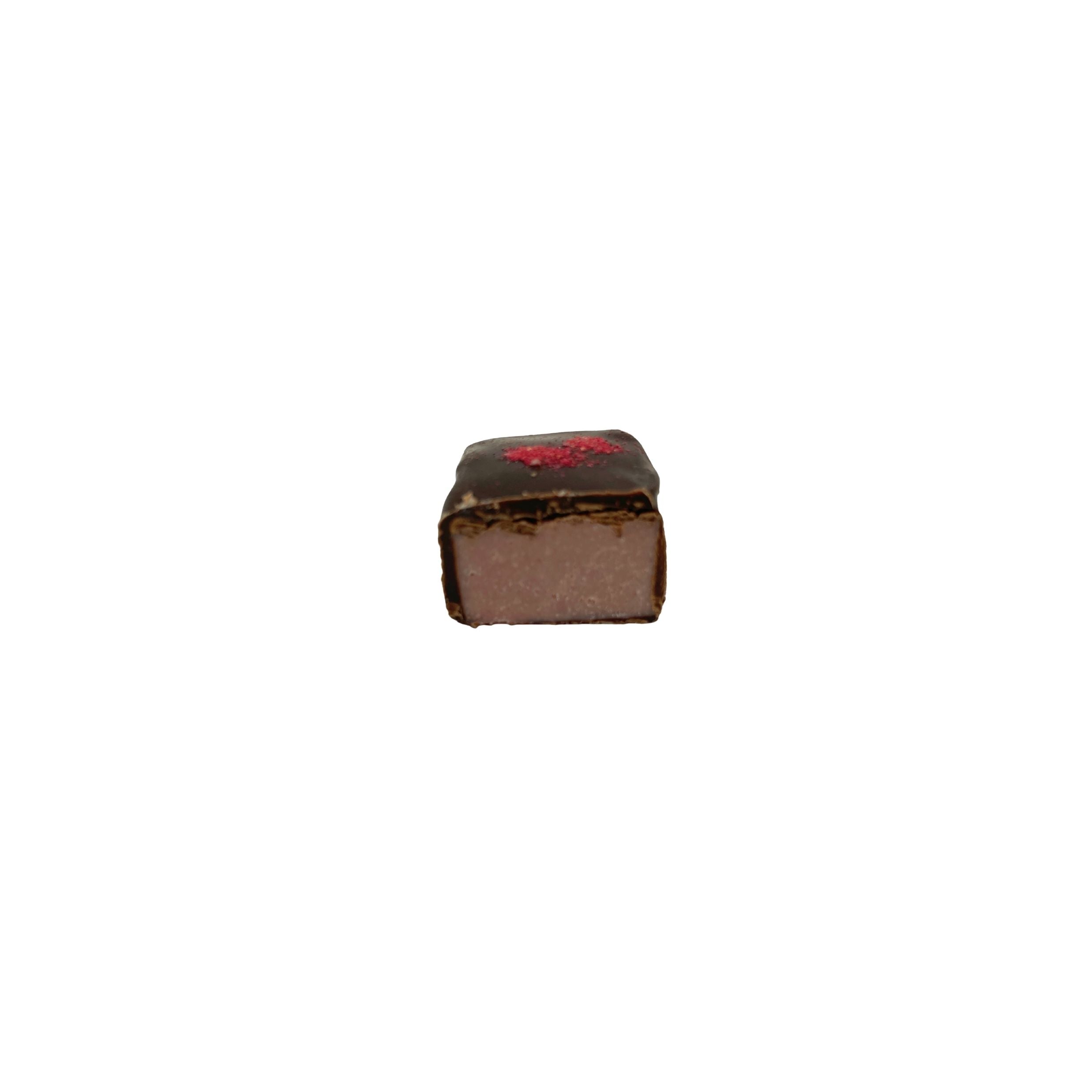 A single square chocolate piece with a dark brown chocolate coating and a light brown filling, featuring a small red decorative detail on top, set against a plain white background.