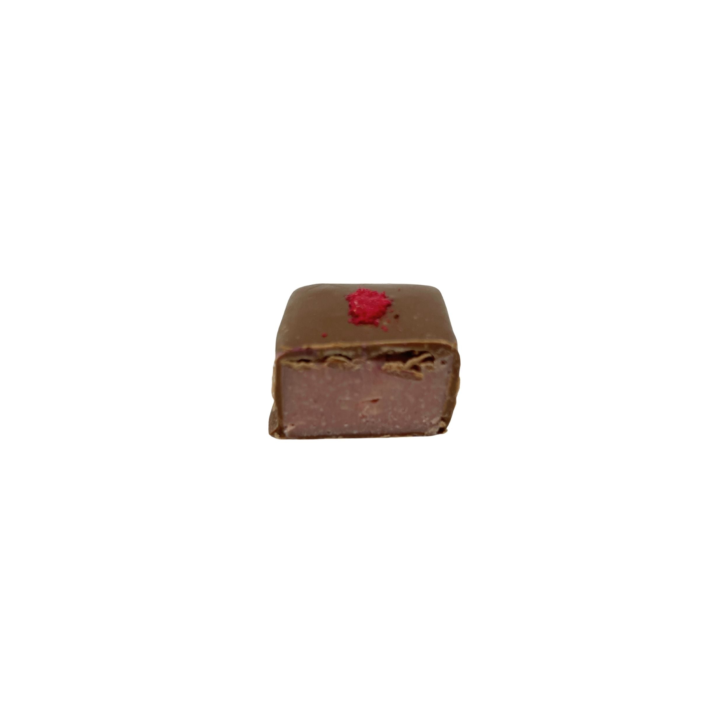 milk chocolate square with open side, red speckles on top