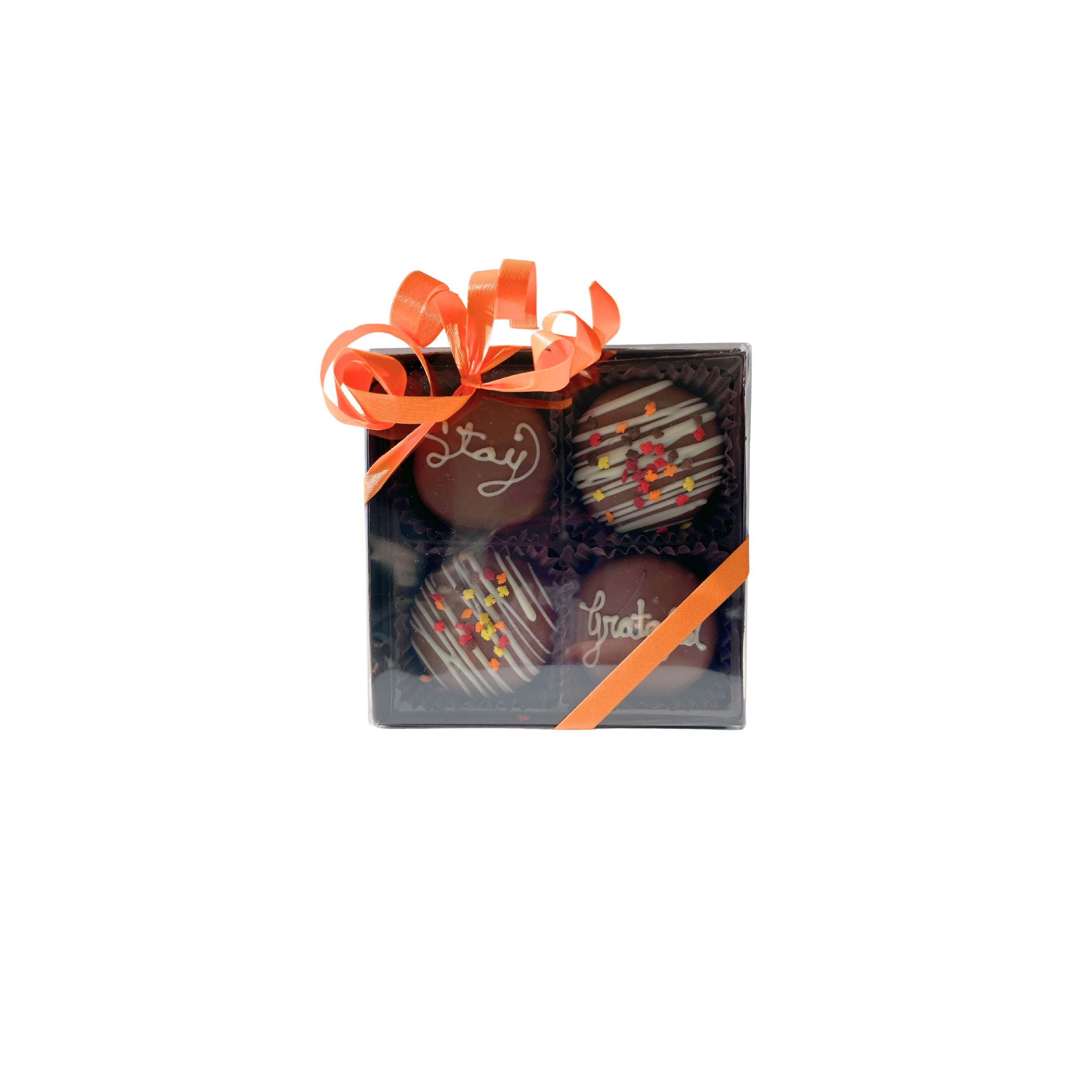 Box of chocolates with orange ribbon on a white background
