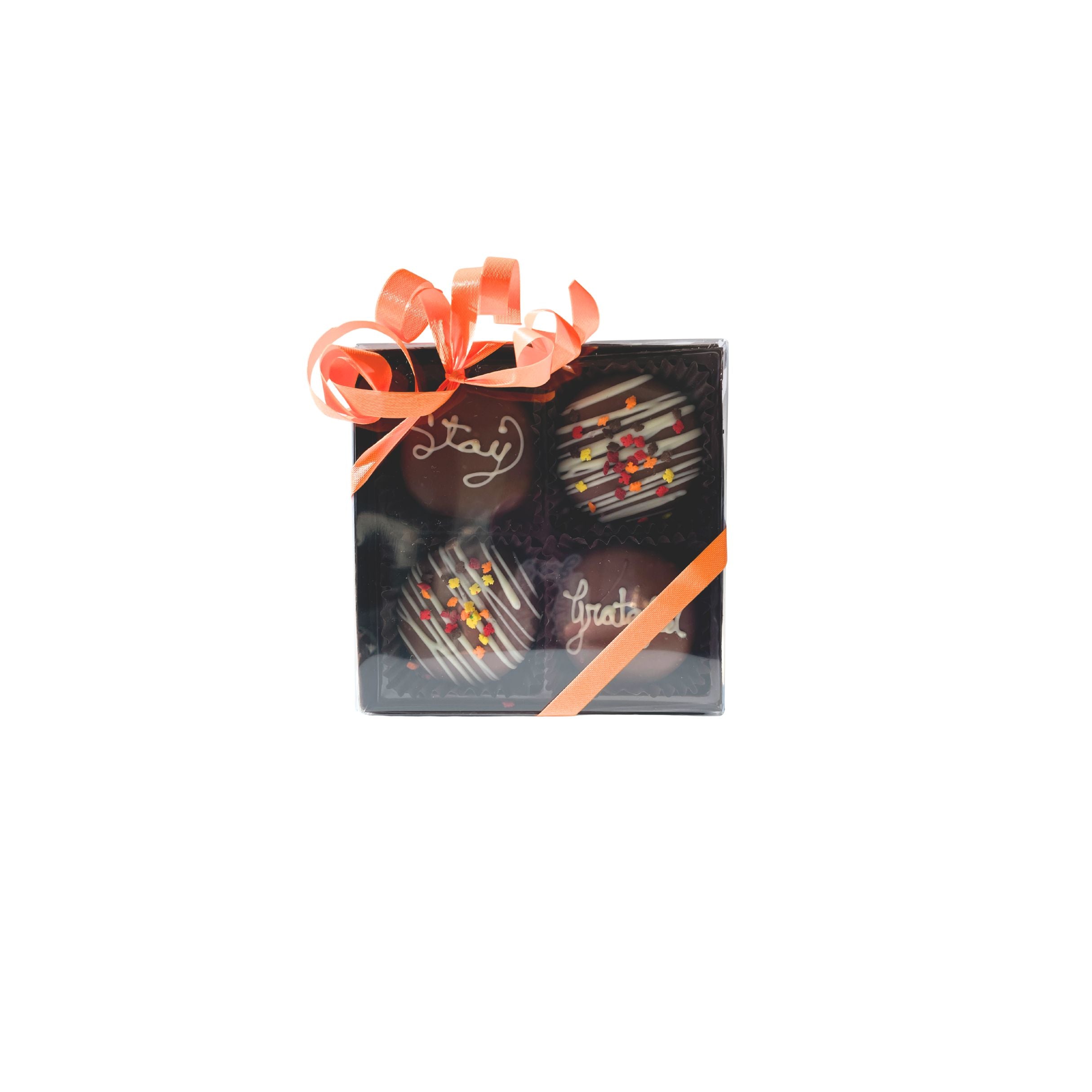 Box of chocolates with a decorative bow on a white background