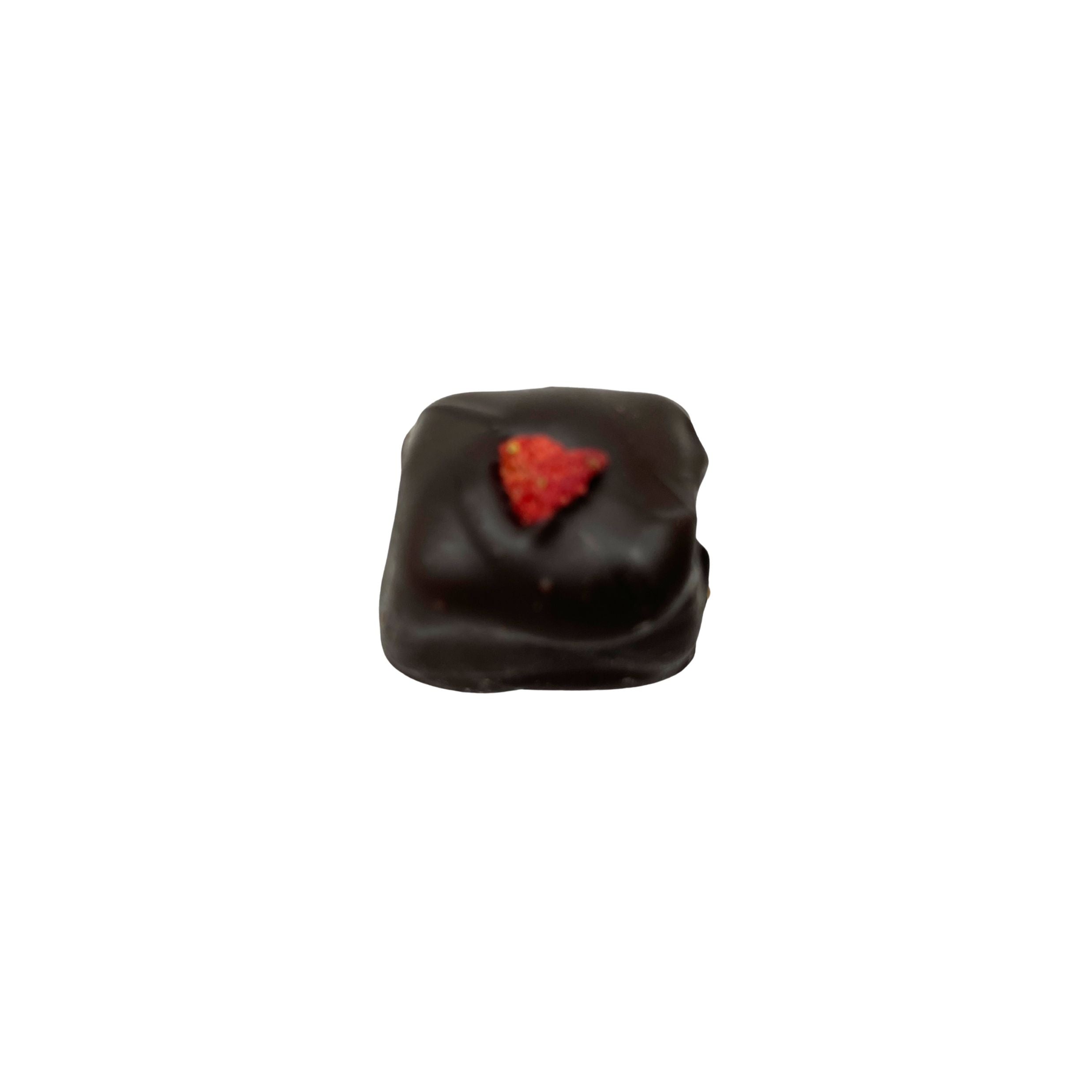 A single square dark chocolate candy with a small red strawberry heart on top, isolated on a white background.