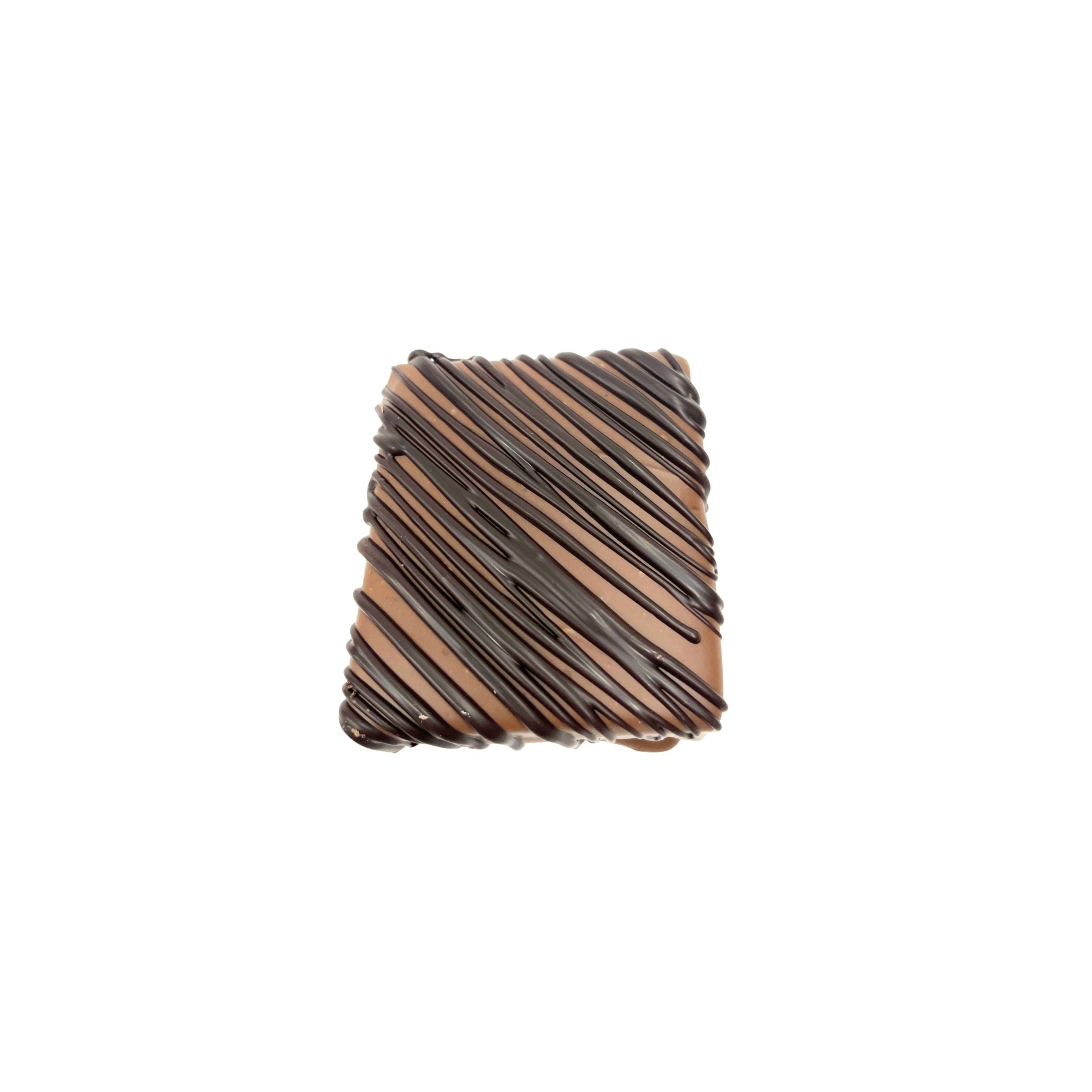 A square chocolate with diagonal dark chocolate drizzle, centered on a plain white background.