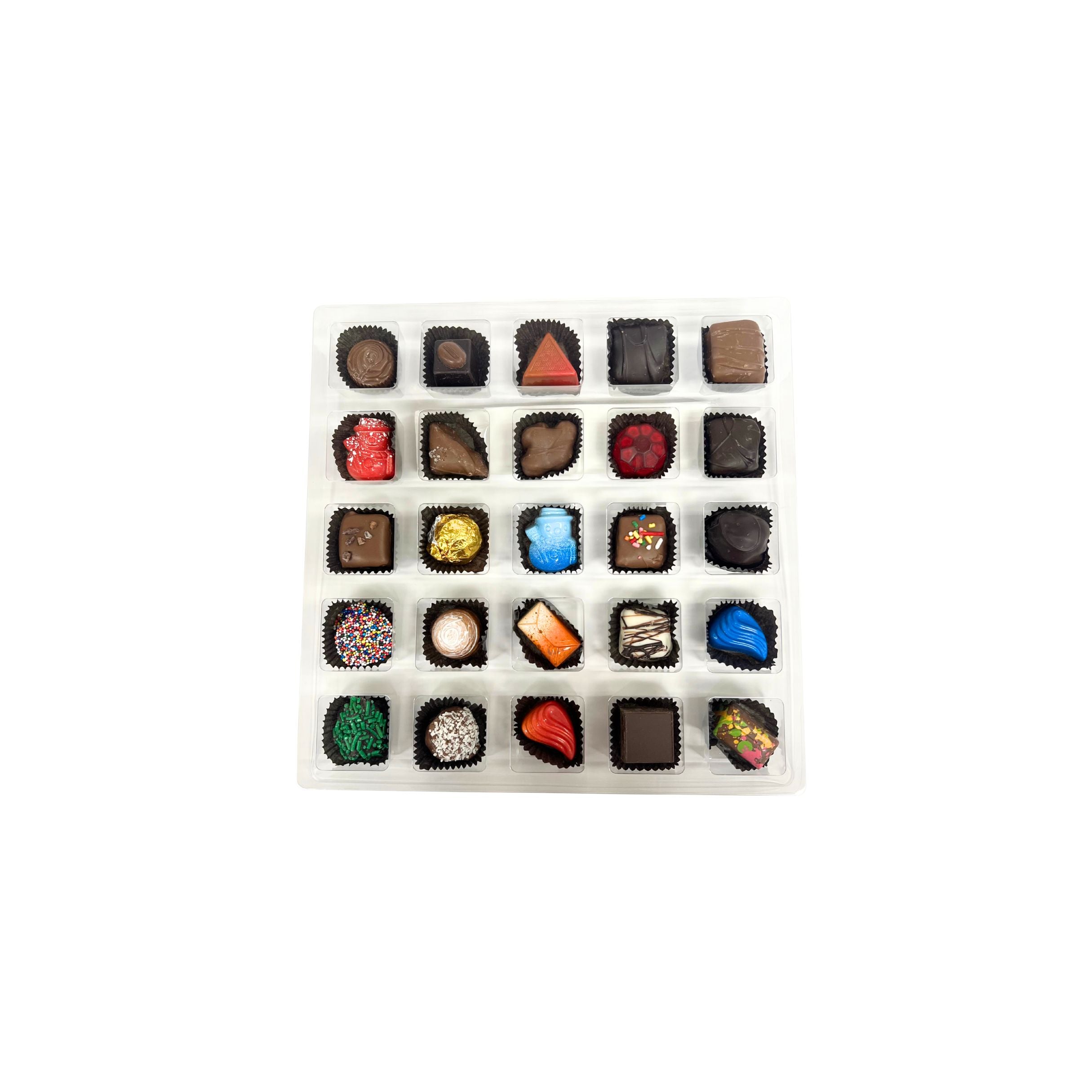 Assorted chocolates in a white box on a white background