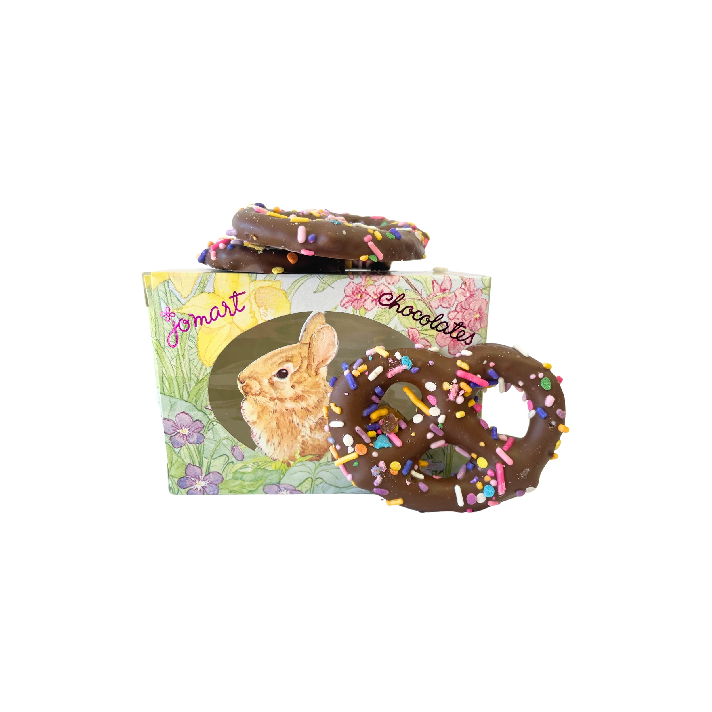 Chocolate pretzels with sprinkles on a box featuring a rabbit illustration, branded 'JoMart Chocolates'.