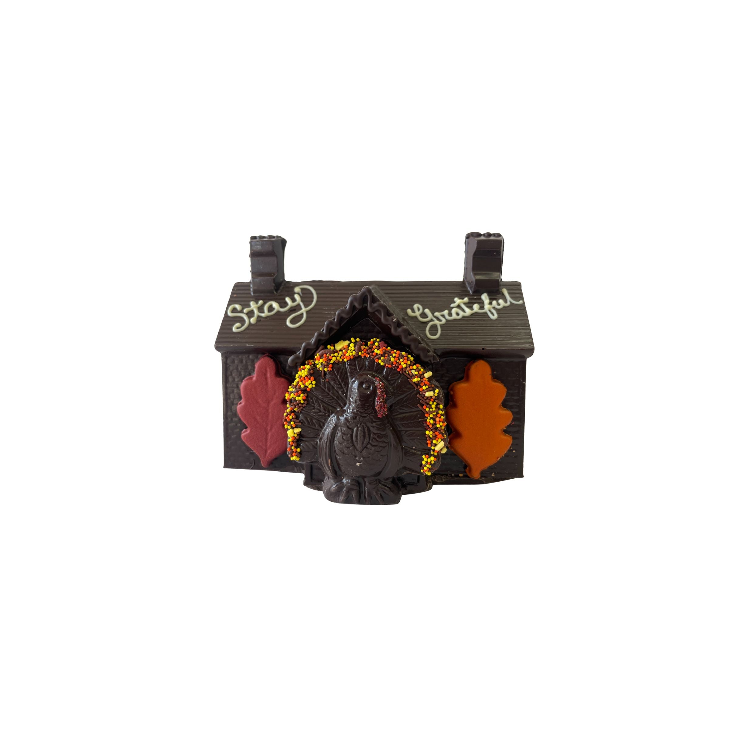 Decorative chocolate house with a turkey design and 'Stay Grateful' text on a white background