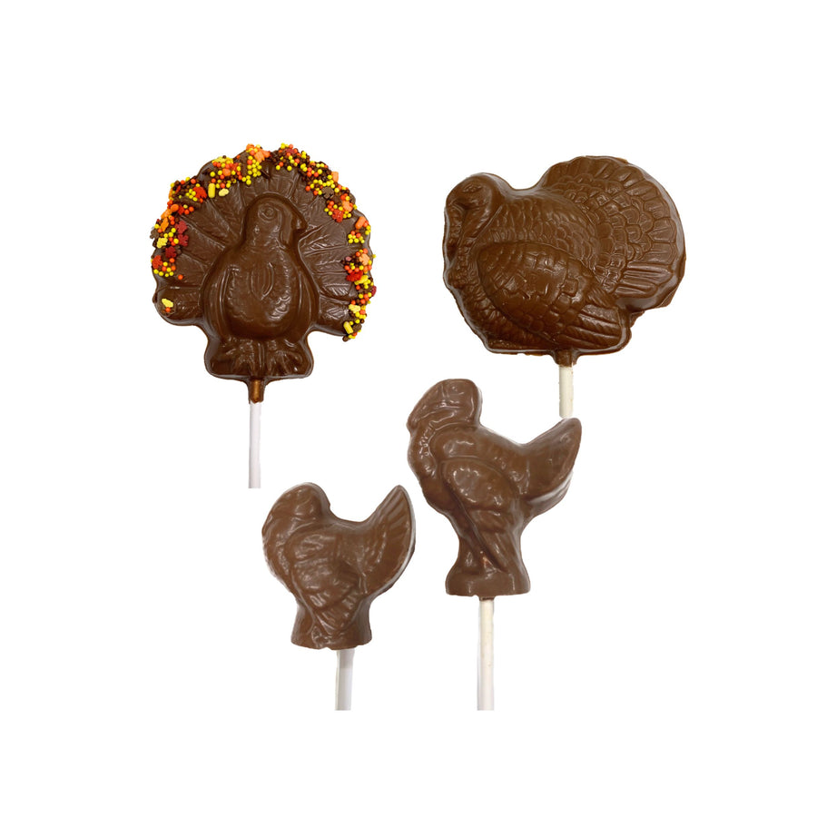 Chocolate lollipops shaped like turkeys on a white background