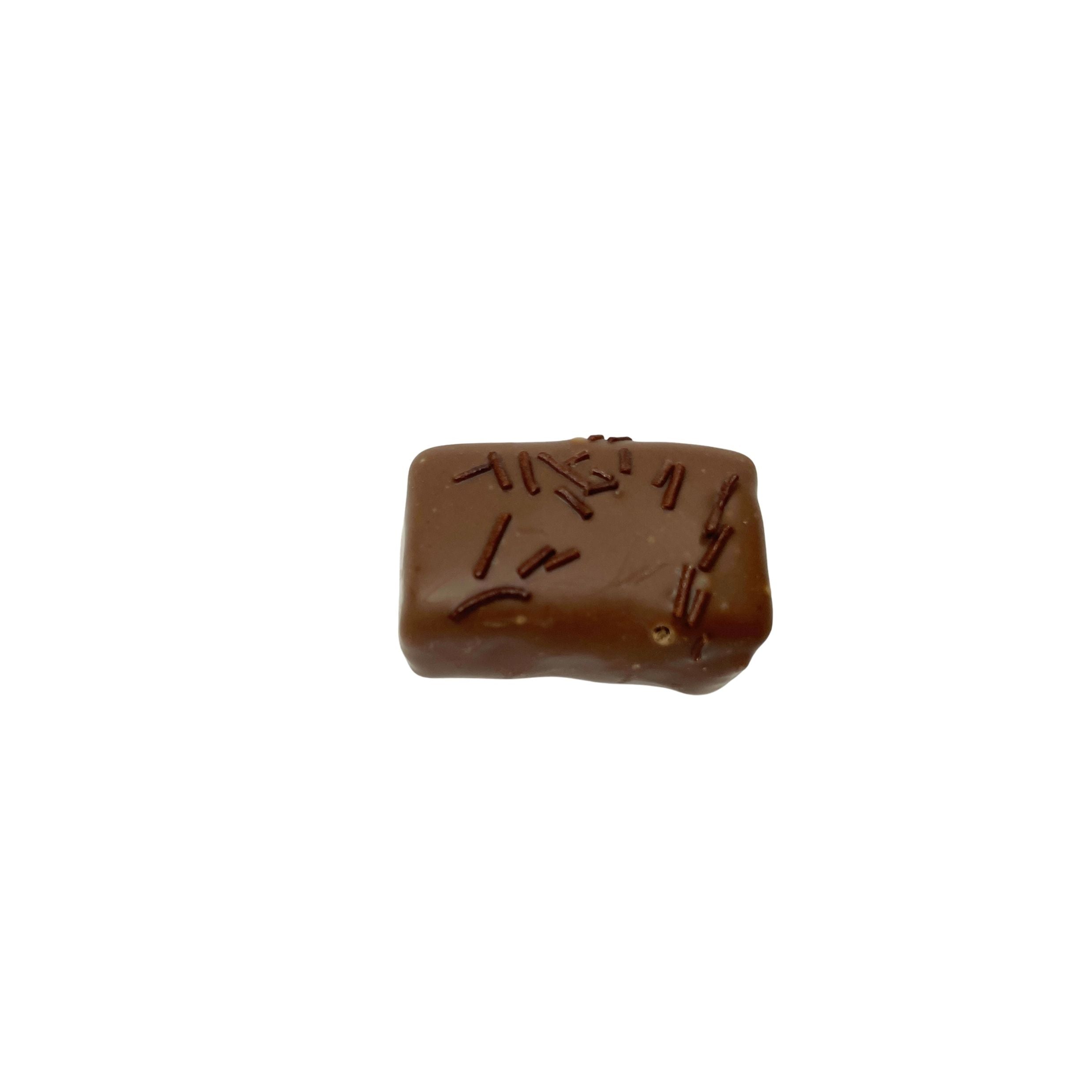 milk chocolate rectangle confection with chocolate sprinkles on a white background
