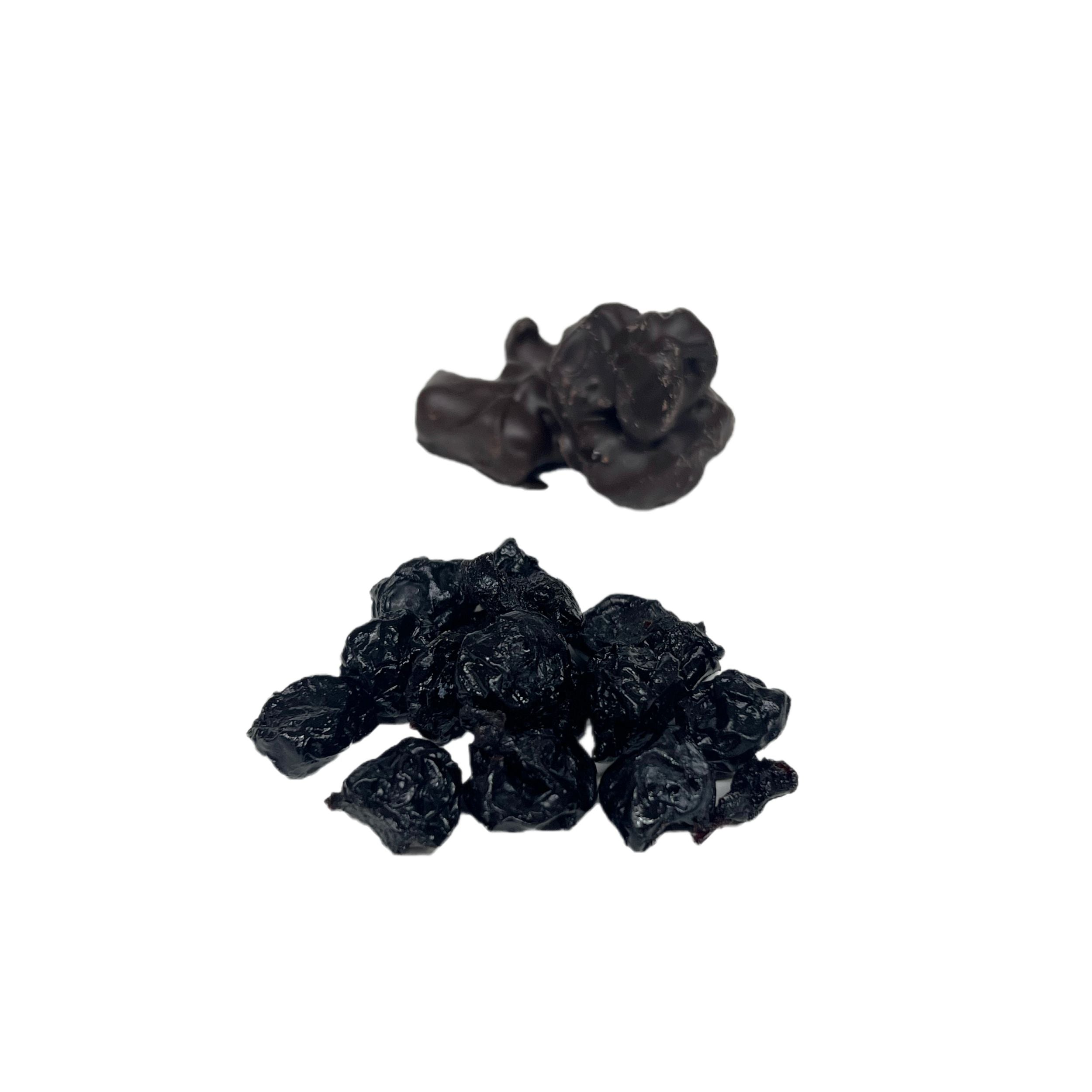 Black dried raisins on a white background