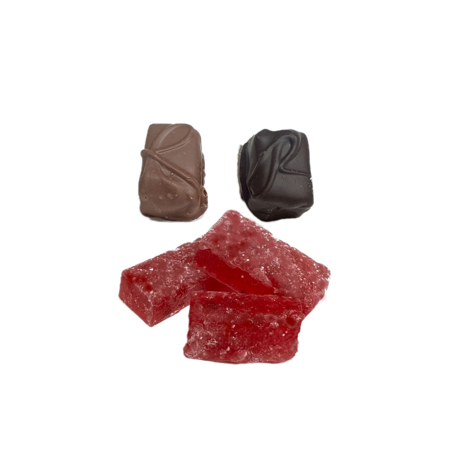 Two chocolate-covered candies and two red jelly candies on a white background