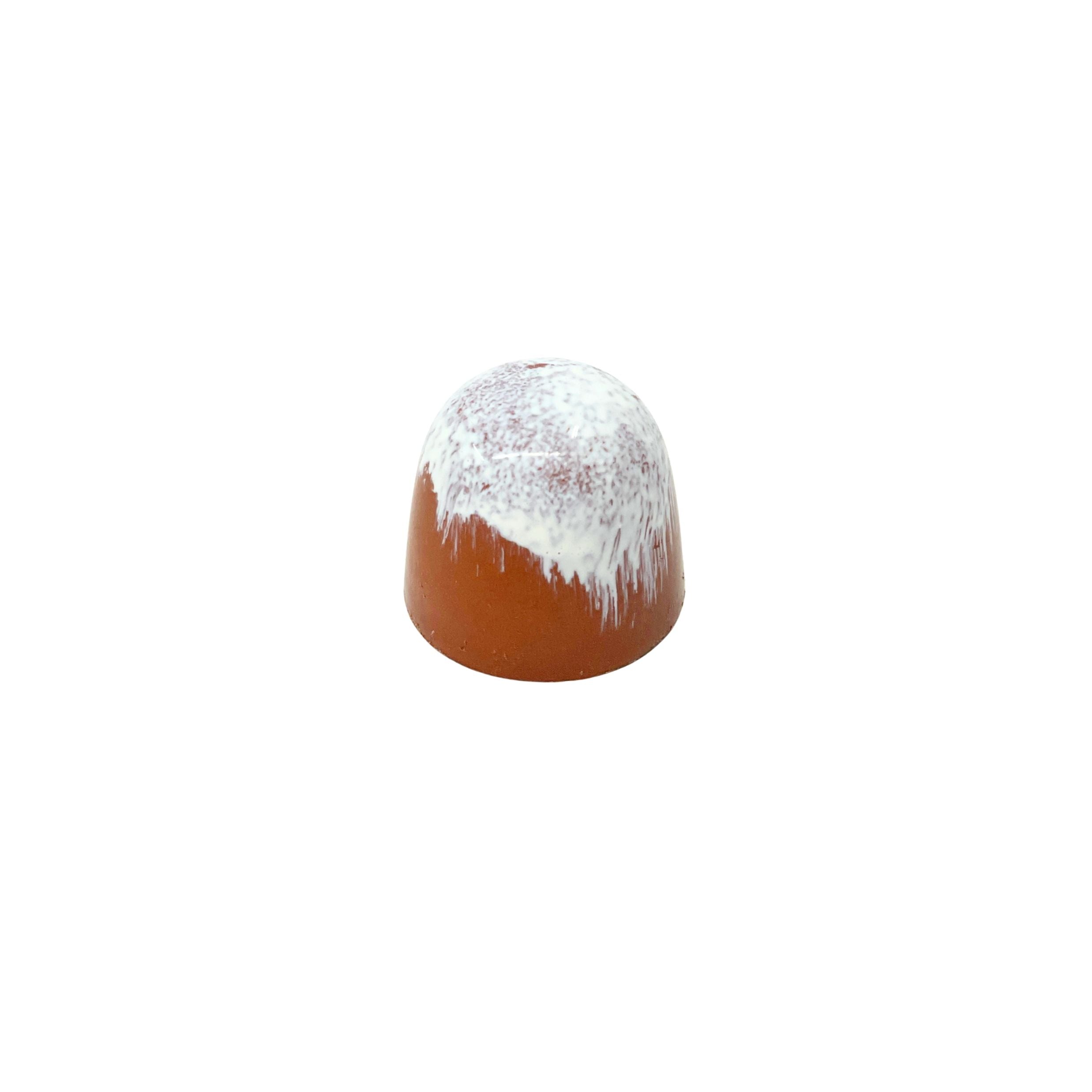 A small dome-shaped chocolate with a glossy reddish-brown lower body and a white glazed top with dripping edges, centered on a plain white background.
